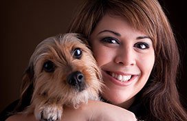 Woman smiling holding dog